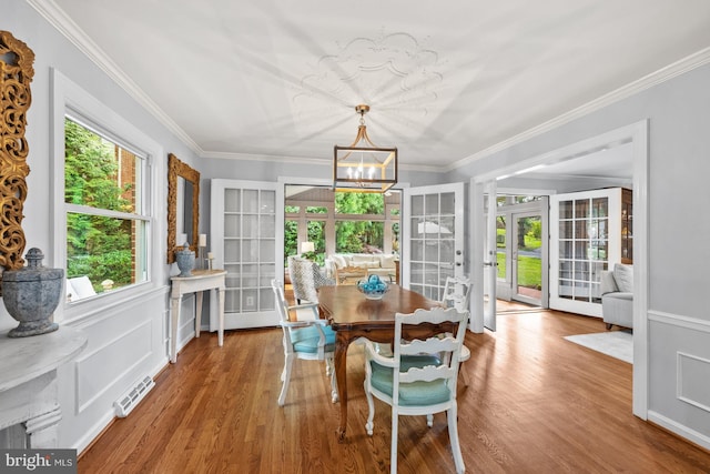 9017 Rouen Ln, Potomac, MD 20854 - dining area featuring french doors, a chandelier, wood finished floors, and ornamental molding