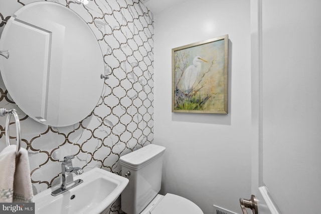 9017 Rouen Ln, Potomac, MD 20854 - bathroom featuring wallpapered walls, a sink, and toilet