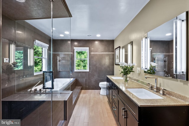 9017 Rouen Ln, Potomac, MD 20854 - full bath featuring a towel warming rack, toilet, wood finished floors, double vanity, and a bath