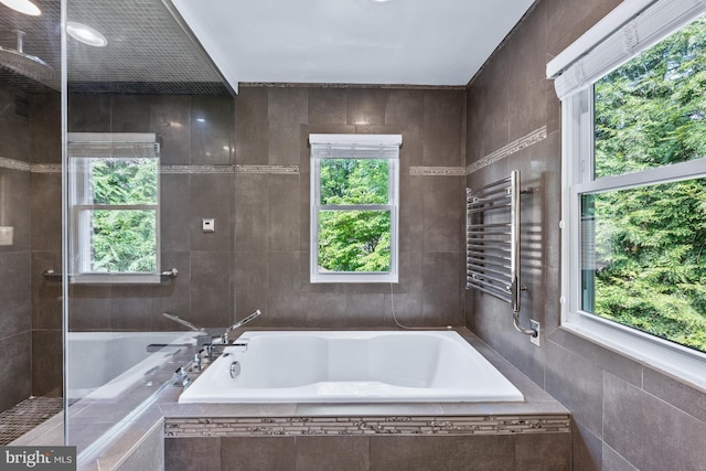 9017 Rouen Ln, Potomac, MD 20854 - bathroom featuring a bath, plenty of natural light, a towel warmer, and radiator heating unit