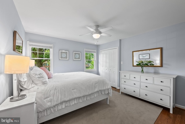 9017 Rouen Ln, Potomac, MD 20854 - bedroom featuring multiple windows, wood finished floors, a closet, and baseboards
