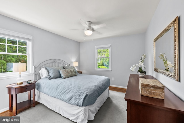 9017 Rouen Ln, Potomac, MD 20854 - bedroom with multiple windows, wood finished floors, and baseboards