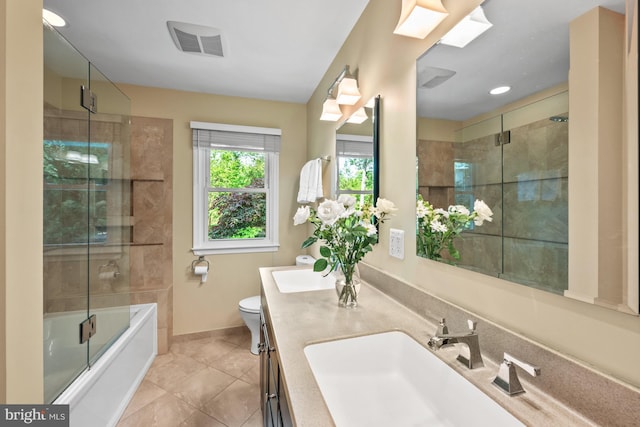 9017 Rouen Ln, Potomac, MD 20854 - bathroom with baseboards, double vanity, toilet, tile patterned floors, and combined bath / shower with glass door