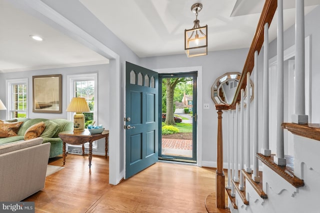 9017 Rouen Ln, Potomac, MD 20854 - foyer with light wood-style flooring, baseboards, ornamental molding, and recessed lighting