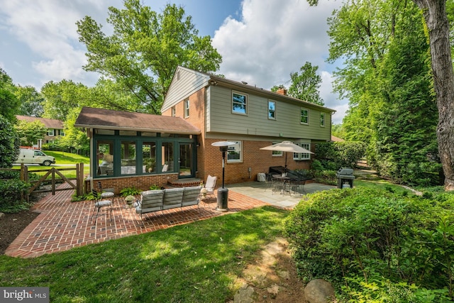 9017 Rouen Ln, Potomac, MD 20854 - back of property featuring a patio, a chimney, a sunroom, brick siding, and a gate
