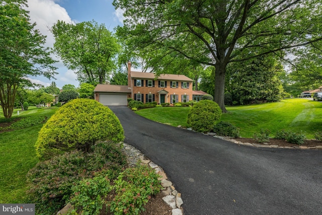 9017 Rouen Ln, Potomac, MD 20854 - colonial-style house with a front yard and a detached garage