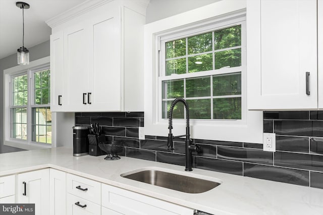 2 Tall Timber Ln, Burlington, NJ 08016 - kitchen with light stone countertops, tasteful backsplash, white cabinetry, and decorative light fixtures