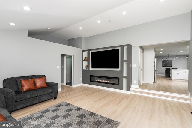 2 Tall Timber Ln, Burlington, NJ 08016 - living area featuring light wood finished floors, recessed lighting, a glass covered fireplace, and vaulted ceiling
