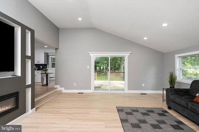 2 Tall Timber Ln, Burlington, NJ 08016 - living room with light wood-style flooring, plenty of natural light, vaulted ceiling, recessed lighting, and a glass covered fireplace