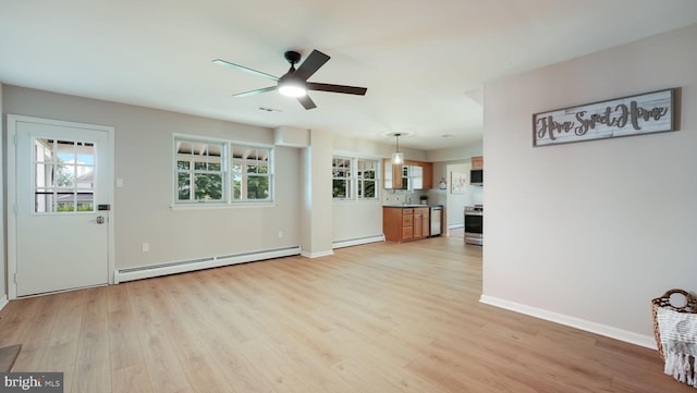 17 Rosemore Dr, Chalfont, PA 18914 - unfurnished living room featuring baseboard heating, a baseboard radiator, ceiling fan, and light wood-style flooring