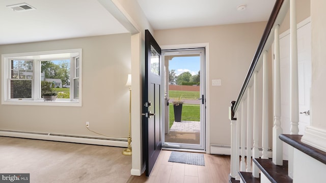 17 Rosemore Dr, Chalfont, PA 18914 - entryway featuring baseboard heating, plenty of natural light, stairway, and light wood-style flooring