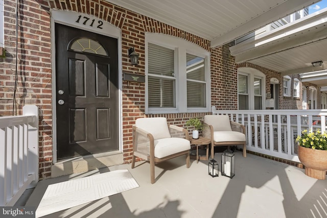 1712 W 14th St, Wilmington, DE 19806 - view of exterior entry featuring covered porch and brick siding