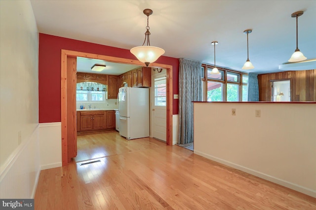 2378 Walnut Bottom Rd, Carlisle, PA 17015 - kitchen featuring freestanding refrigerator, brown cabinets, light wood-type flooring, and pendant lighting