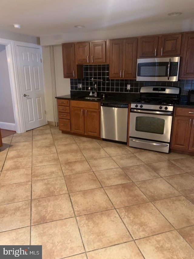 439 Prospect St, Bridgeport, PA 19405 - kitchen with stainless steel appliances, dark countertops, and tasteful backsplash