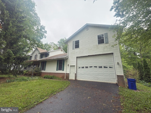 1701 Underwood Rd, Sykesville, MD 21784 - traditional-style home featuring an attached garage, driveway, brick siding, and a front lawn