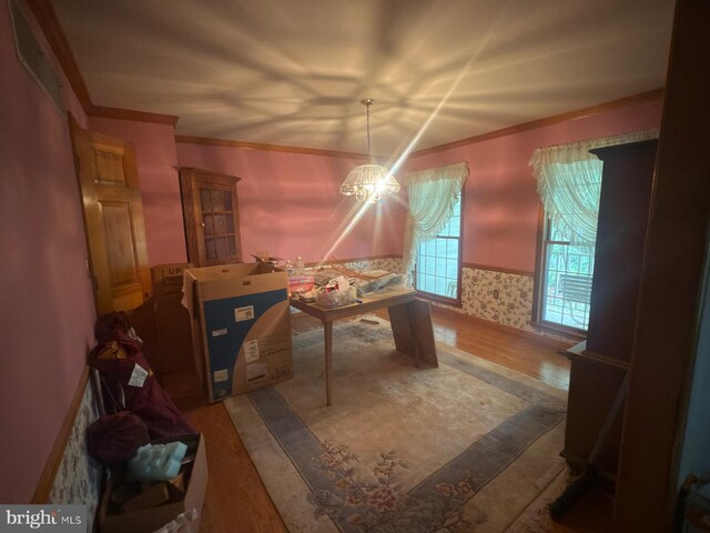 1701 Underwood Rd, Sykesville, MD 21784 - dining space featuring wood finished floors, crown molding, and a chandelier