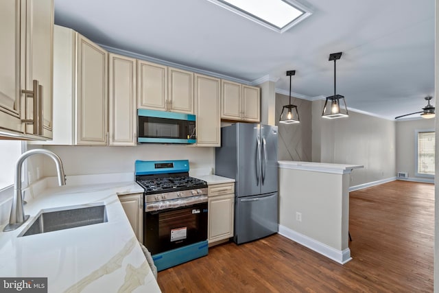 1521 Bush St, Baltimore, MD 21230 - kitchen with stainless steel appliances, cream cabinetry, crown molding, dark wood-style flooring, and open floor plan
