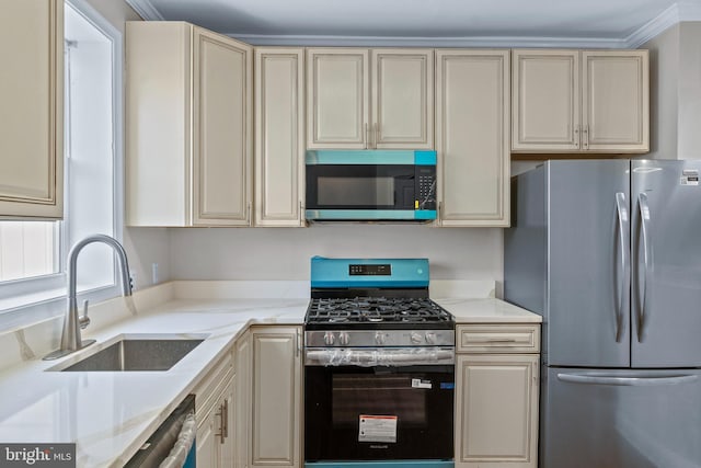 1521 Bush St, Baltimore, MD 21230 - kitchen with stainless steel appliances, cream cabinets, crown molding, and light stone counters