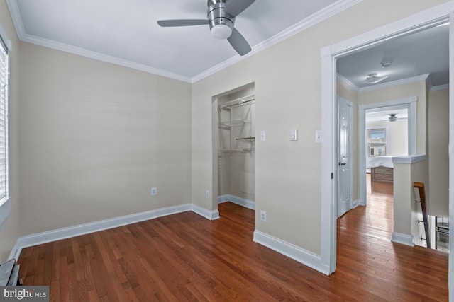 1521 Bush St, Baltimore, MD 21230 - unfurnished bedroom with dark wood-style flooring, crown molding, a closet, a walk in closet, and a ceiling fan