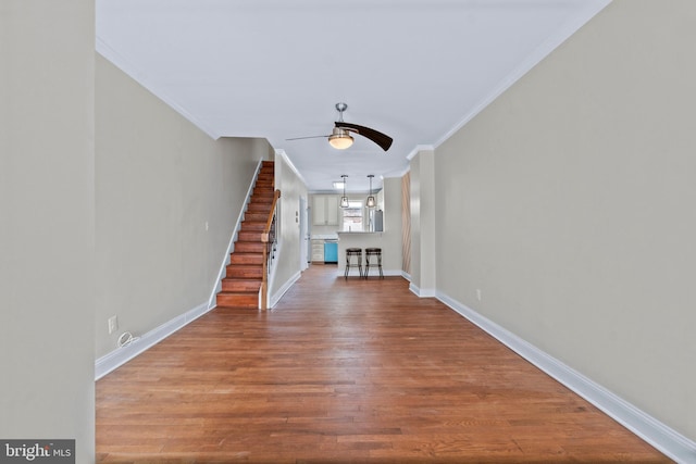 1521 Bush St, Baltimore, MD 21230 - unfurnished living room with a ceiling fan, ornamental molding, wood finished floors, and stairway