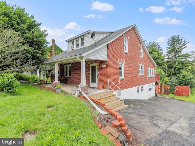 12225 Upper Georges Creek Rd SW, Frostburg, MD 21532 - view of front of house with brick siding, a porch, asphalt driveway, and roof with shingles