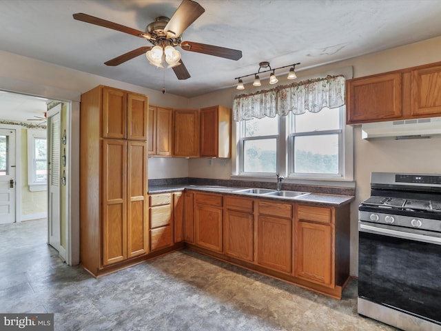 12225 Upper Georges Creek Rd SW, Frostburg, MD 21532 - kitchen featuring stainless steel gas stove, under cabinet range hood, a ceiling fan, brown cabinets, and dark countertops