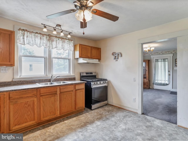 12225 Upper Georges Creek Rd SW, Frostburg, MD 21532 - kitchen with stainless steel gas range, under cabinet range hood, brown cabinetry, and a ceiling fan