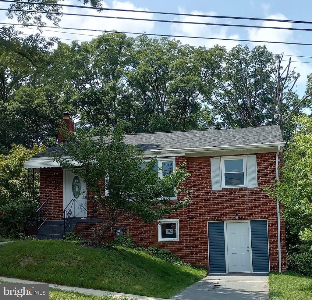 4914 66th Ave, Hyattsville, MD 20784 - view of front of property with brick siding, a chimney, and a front yard
