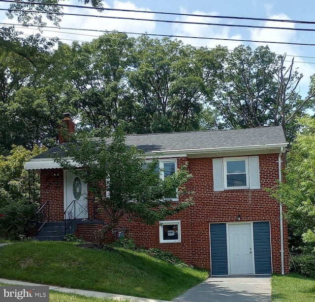 4914 66th Ave, Hyattsville, MD 20784 - view of front of property with brick siding, a chimney, and a front yard