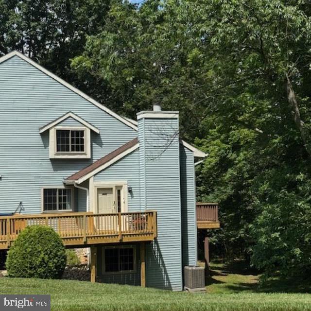 303 Green Meadow Ln, Horsham, PA 19044 - rear view of house featuring a wooden deck, a lawn, and a chimney