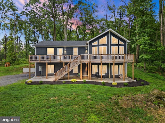 2554 High Top Rd, Linden, VA 22642 - back of property at dusk with a patio, a deck, a lawn, and stairway