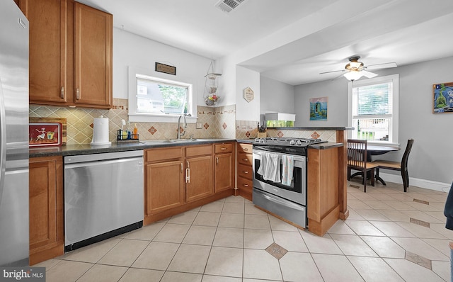 320 Pearl Ave, Horsham, PA 19044 - kitchen featuring appliances with stainless steel finishes, a sink, brown cabinets, and healthy amount of natural light