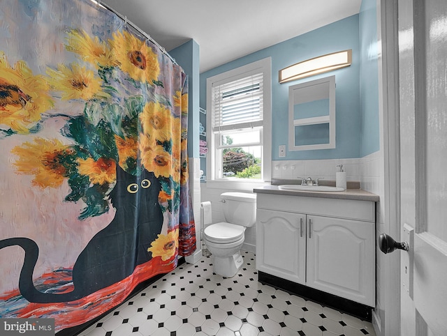 320 Pearl Ave, Horsham, PA 19044 - bathroom featuring vanity, toilet, wainscoting, tile walls, and tile patterned floors
