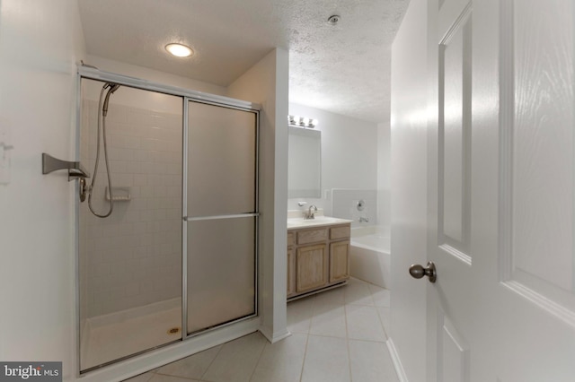 Goose Landing Cir, Columbia, MD 21044 - full bath featuring tile patterned floors, a stall shower, vanity, a garden tub, and a textured ceiling