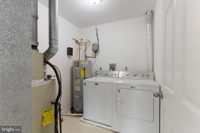 Goose Landing Cir, Columbia, MD 21044 - laundry room featuring separate washer and dryer, electric water heater, and a textured ceiling