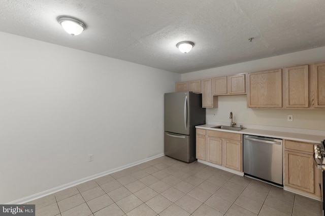 Goose Landing Cir, Columbia, MD 21044 - kitchen with stainless steel appliances, light brown cabinetry, a sink, and a textured ceiling