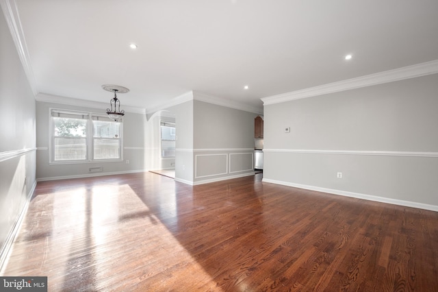 2413 Childs Ln, Alexandria, VA 22308 - unfurnished living room with arched walkways, crown molding, wood finished floors, recessed lighting, and a chandelier
