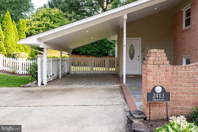 2413 Childs Ln, Alexandria, VA 22308 - exterior space with concrete driveway, brick siding, and an attached carport