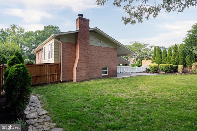 2413 Childs Ln, Alexandria, VA 22308 - back of house with a chimney, brick siding, and a patio