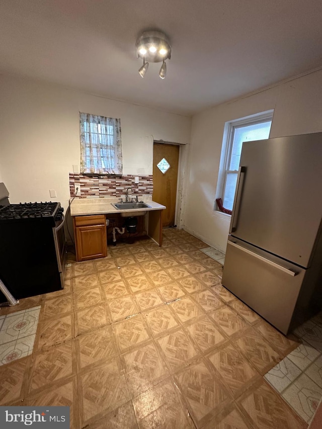 1924 S 21st St, Philadelphia, PA 19145 - kitchen with appliances with stainless steel finishes, light countertops, and brown cabinetry