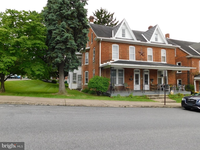 46-48 W Third St, Waynesboro, PA 17268 - multi unit property featuring a porch, brick siding, a chimney, and a front lawn