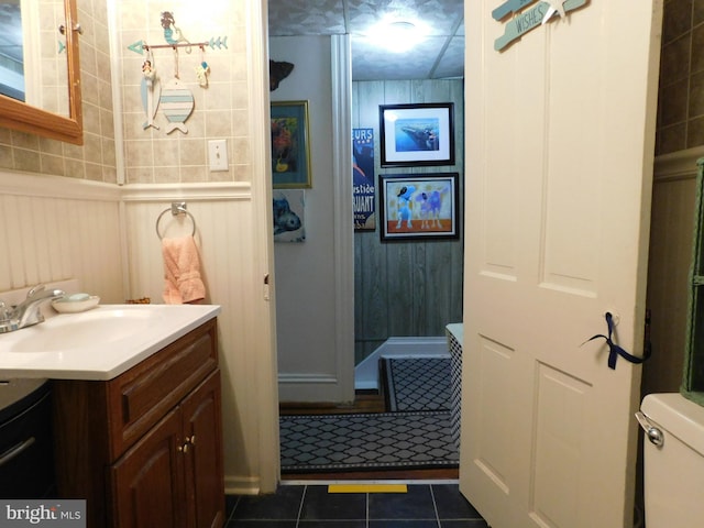 46-48 W Third St, Waynesboro, PA 17268 - bathroom with vanity, tile patterned flooring, and a decorative wall