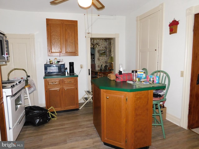 46-48 W Third St, Waynesboro, PA 17268 - kitchen featuring black microwave, white gas stove, wood finished floors, and dark countertops