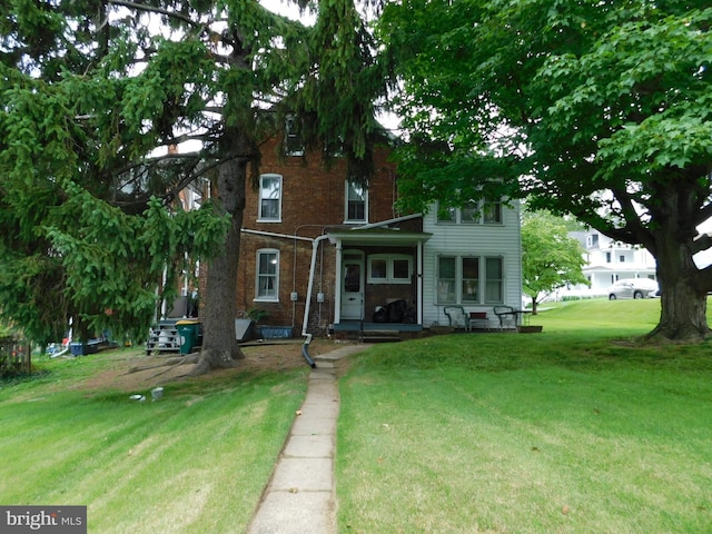 46-48 W Third St, Waynesboro, PA 17268 - rear view of property featuring brick siding and a lawn