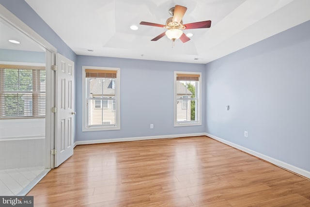 10728 Horde St, Silver Spring, MD 20902 - empty room featuring a tray ceiling, light wood-style floors, ceiling fan, and baseboards