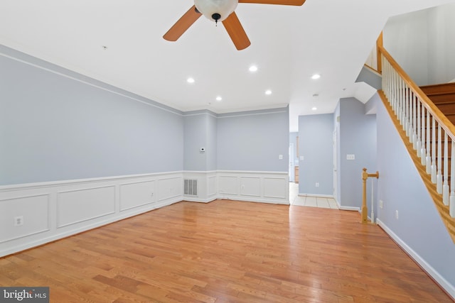 10728 Horde St, Silver Spring, MD 20902 - empty room featuring a ceiling fan, wainscoting, light wood-style floors, stairs, and recessed lighting