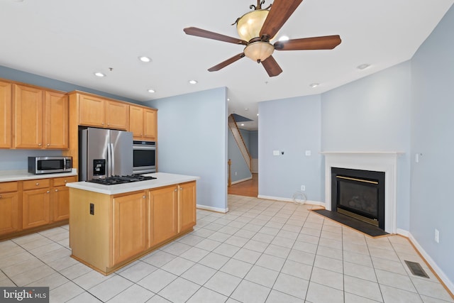 10728 Horde St, Silver Spring, MD 20902 - kitchen featuring appliances with stainless steel finishes, light countertops, ceiling fan, baseboards, and a center island