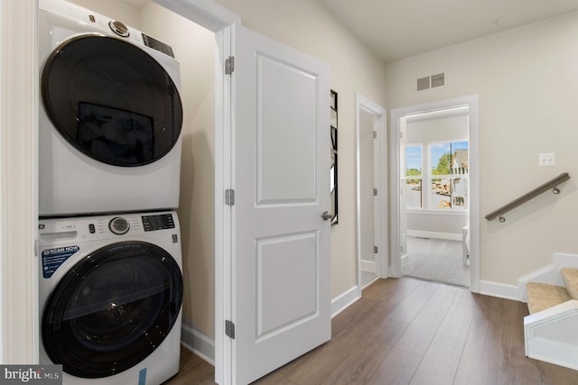 6061 Beake St, Hyattsville, MD 20782 - washroom featuring stacked washing machine and dryer, wood finished floors, and baseboards