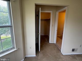 205 Rachel Ct, Franklin Park, NJ 08823 - unfurnished bedroom featuring a spacious closet, multiple windows, carpet, and a closet