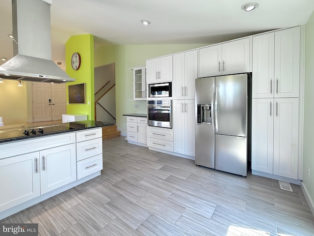 231 E Juniper Ave, Sterling, VA 20164 - kitchen with appliances with stainless steel finishes, wall chimney range hood, vaulted ceiling, white cabinets, and recessed lighting